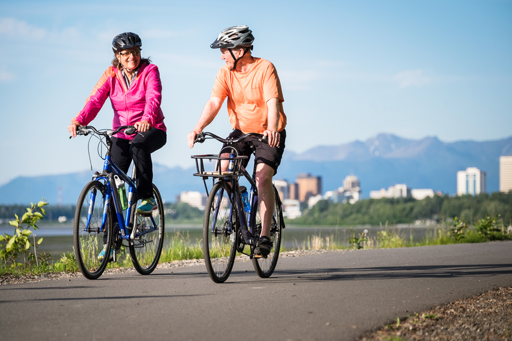 A Couple Riding Bikes on the Tony Knowles Coastal Trail